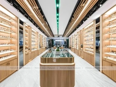 Warm Walnut Eyewear Showroom with Symmetrical Display Corridor