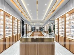 Warm Walnut Eyewear Showroom with Symmetrical Display Corridor