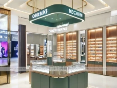 Warm Walnut Eyewear Showroom with Symmetrical Display Corridor