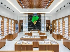 Warm Walnut Vision Store Interior with Symmetrical Display Corridor
