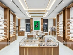 Warm Walnut Vision Store Interior with Symmetrical Display Corridor