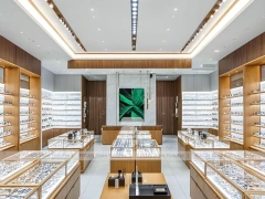 Warm Walnut Vision Store Interior with Symmetrical Display Corridor