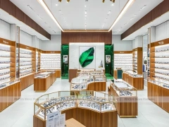 Warm Walnut Vision Store Interior with Symmetrical Display Corridor