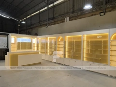 Warm White Perfume Aisle With Arch Shelving