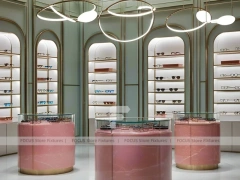Green Accent Optical Consultation Lounge with Round Pink Pedestals