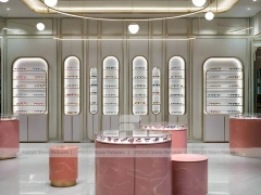 Green Accent Optical Consultation Lounge with Round Pink Pedestals