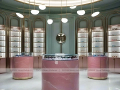 Green Accent Optical Consultation Lounge with Round Pink Pedestals