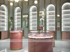 Green Accent Optical Consultation Lounge with Round Pink Pedestals