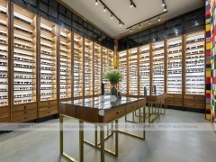 Teal Gold Eyewear Gallery Interior with Chandelier-Lit Island