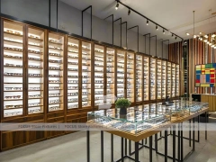 Teal Gold Eyewear Gallery Interior with Chandelier-Lit Island