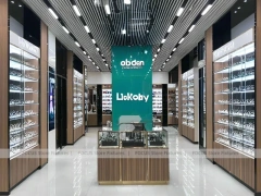 Teal Gold Vision Retail Showcase with Chandelier-Lit Island