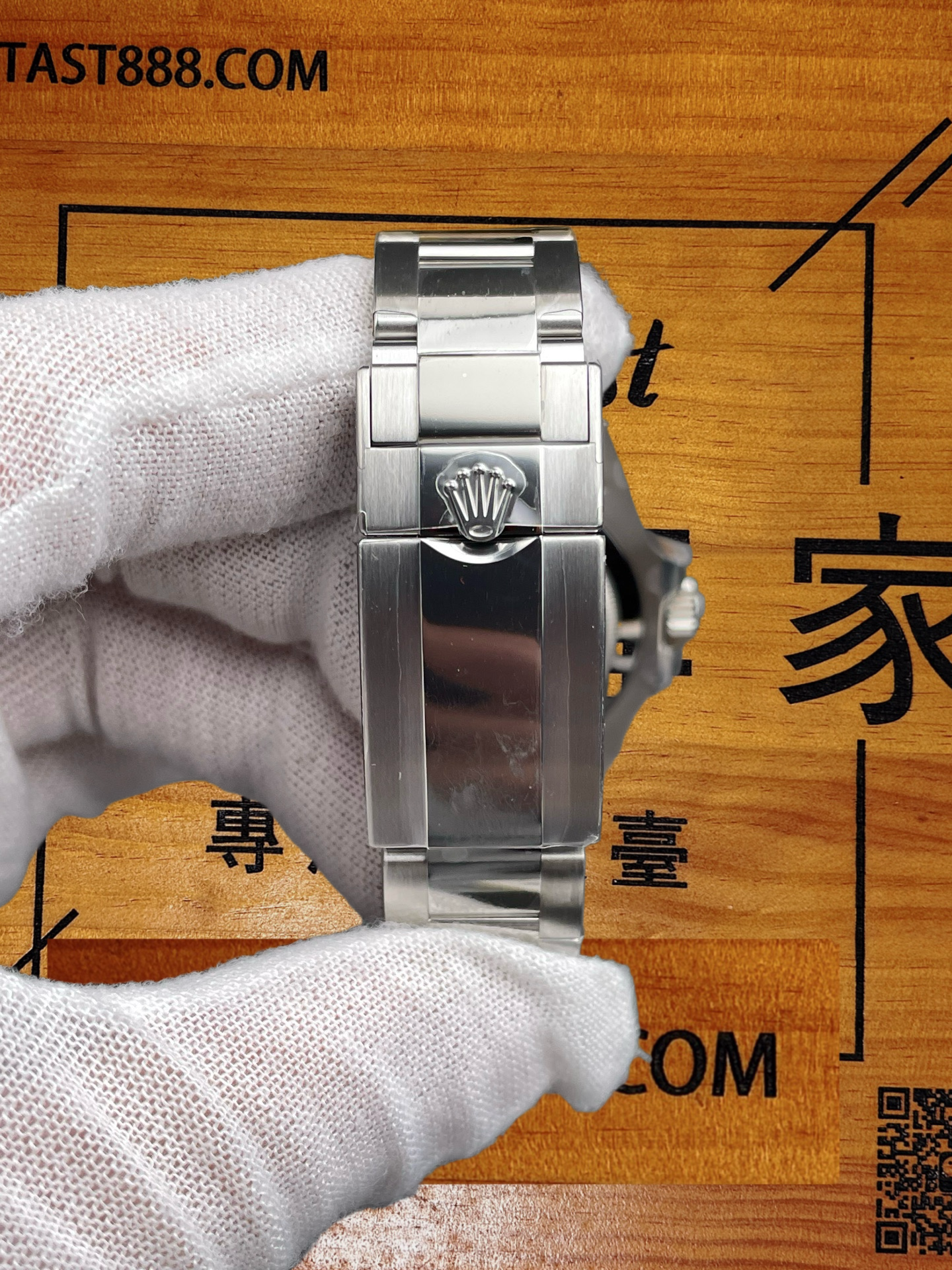 勞力士復刻腕錶錶冠側面特寫，白手套手持，突出錶殼打磨工藝，背景木紋印有FANTAST888.COM及「專注港澳台」文字。