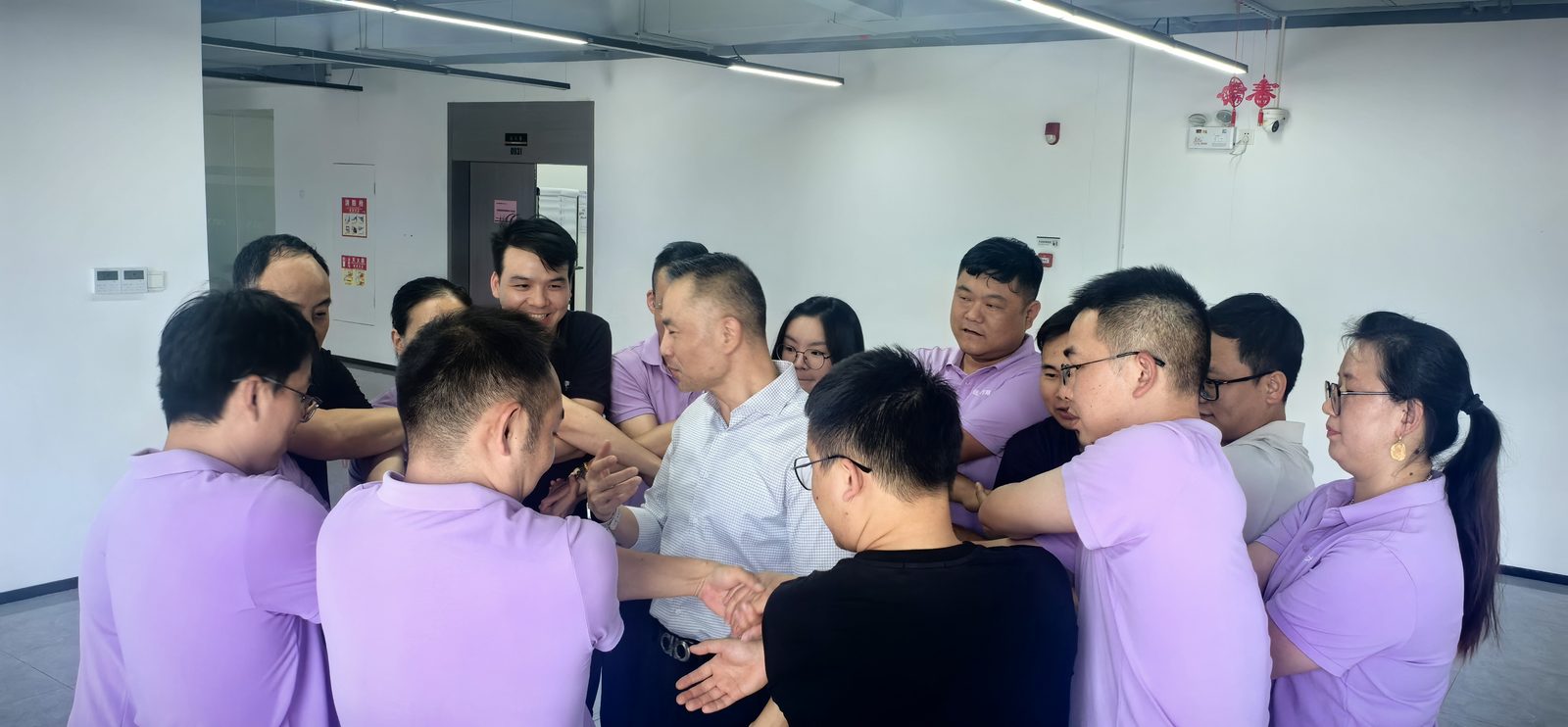 Team members joining hands in an interactive activity