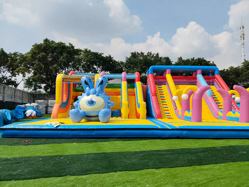 Module 3 - Large inflatable slides with giant cartoon monster signage and branding