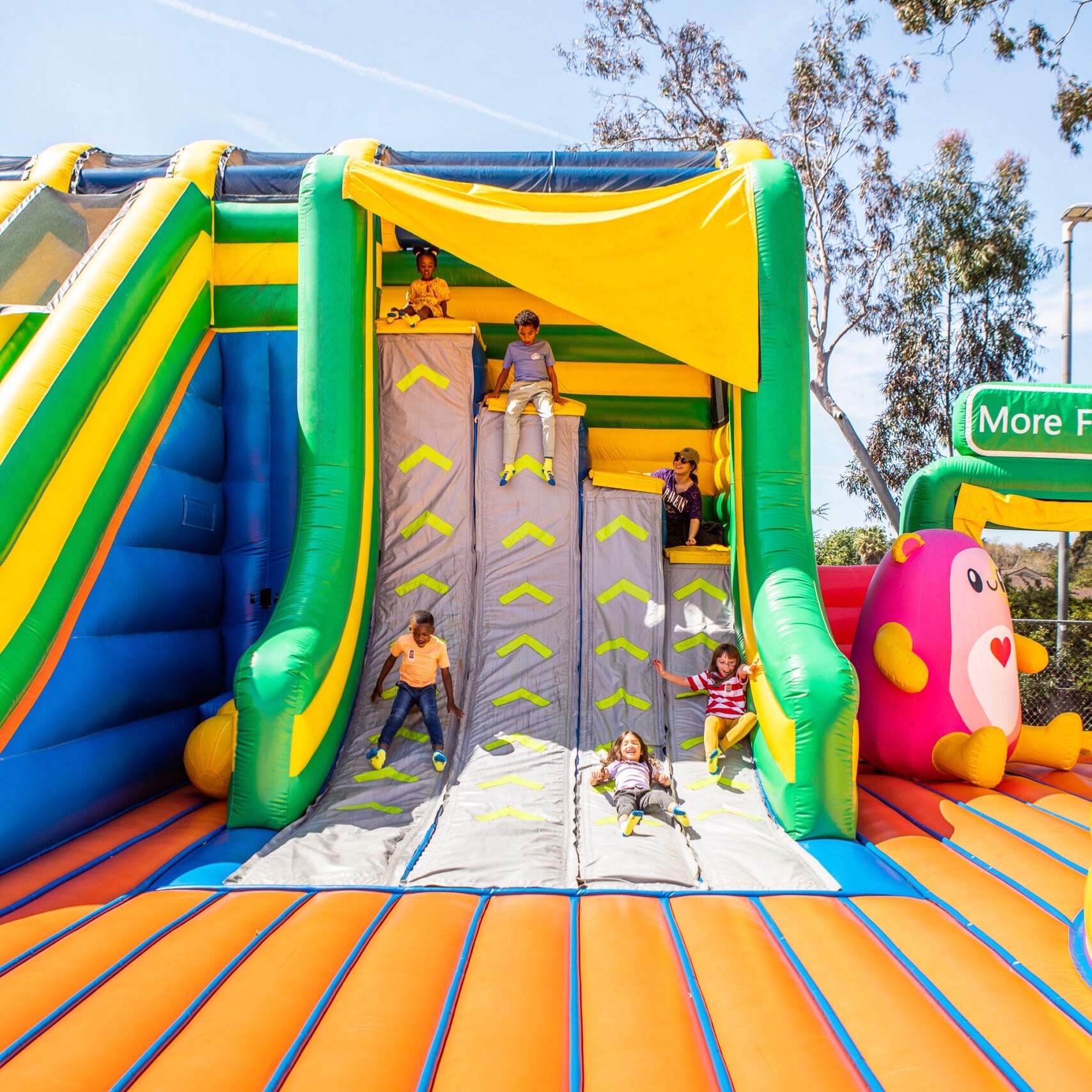 Children playing in inflatable park
