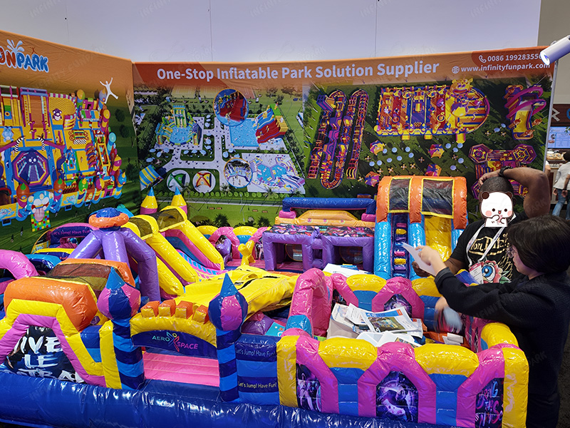 Infinity Funpark booth showcasing inflatable park models at IAAPA Expo 2025