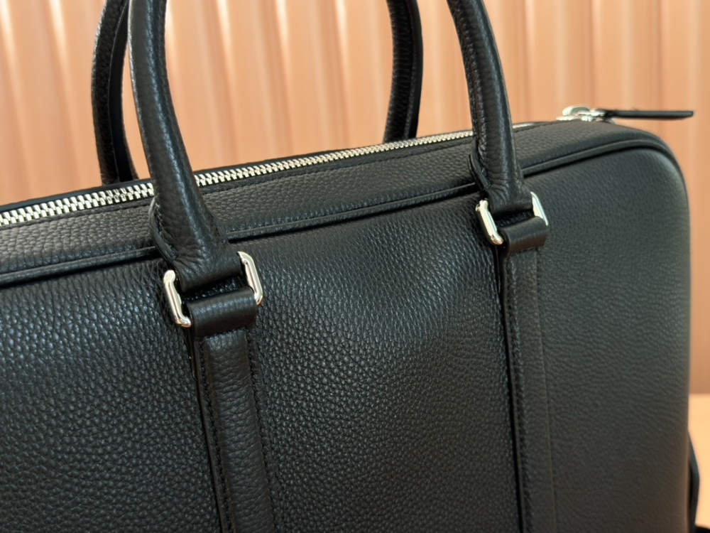 The briefcase is crafted with exquisite grain leather