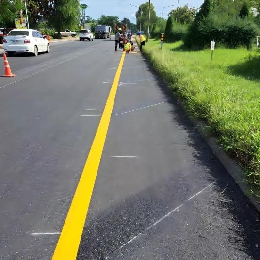 Road marking machine applying paint