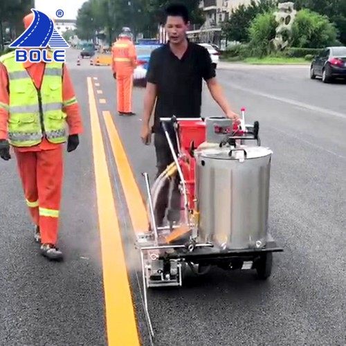 Bole thermoplastic road marking paint being painted using a road marking machine