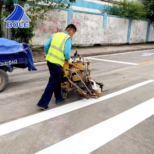 Bole thermoplastic road marking paint being painted using a thermoplastic road marking machine