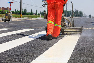 Close-up of reflective glass beads embedded in thermoplastic road marking paint for retroreflectivity