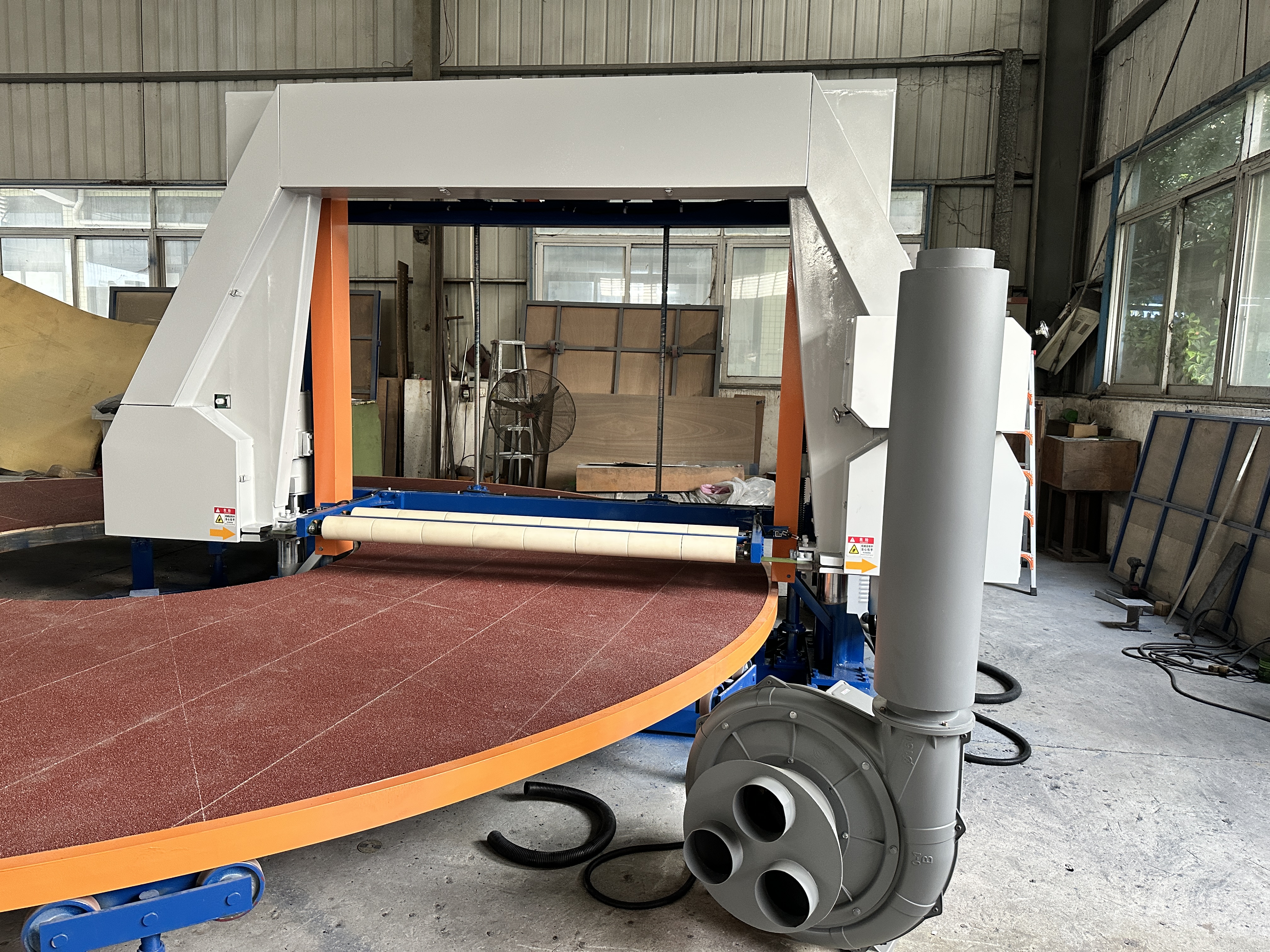 Industrial foam cutting production line showing automated feeding and material handling systems