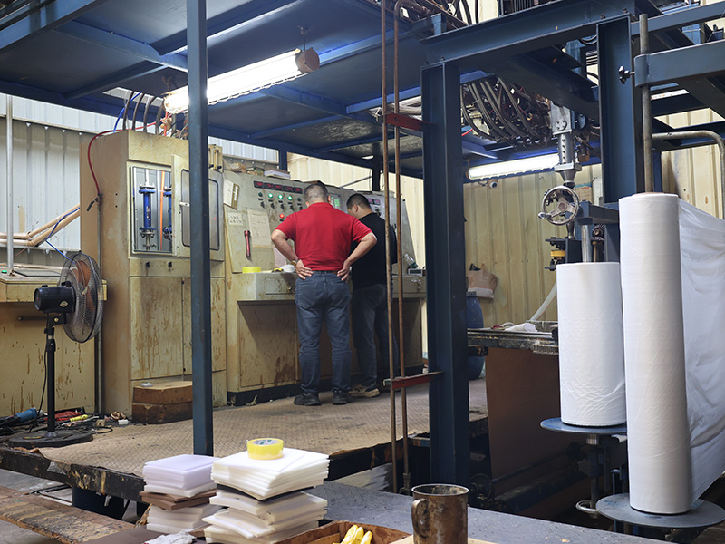 Operators monitoring automatic foaming line control panel