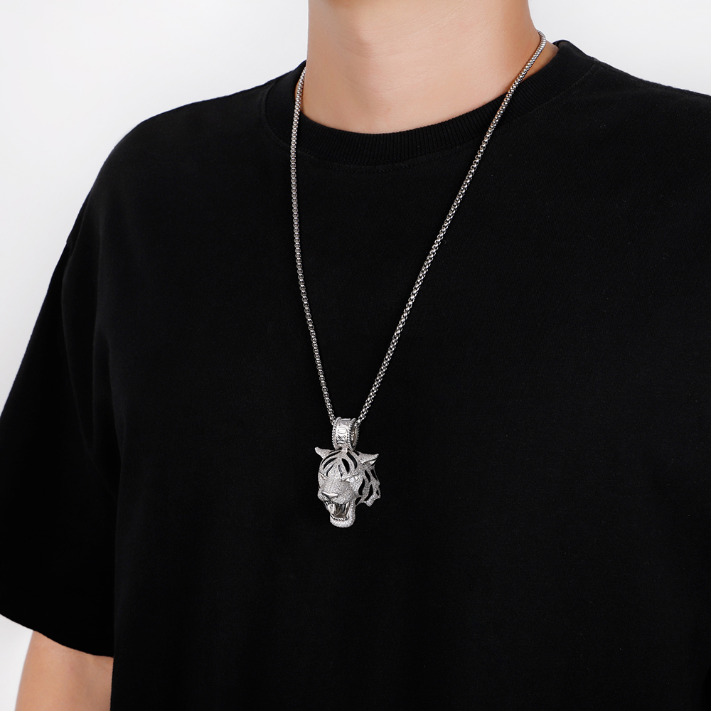 Man wearing streetwear silver tiger necklace with hoodie.