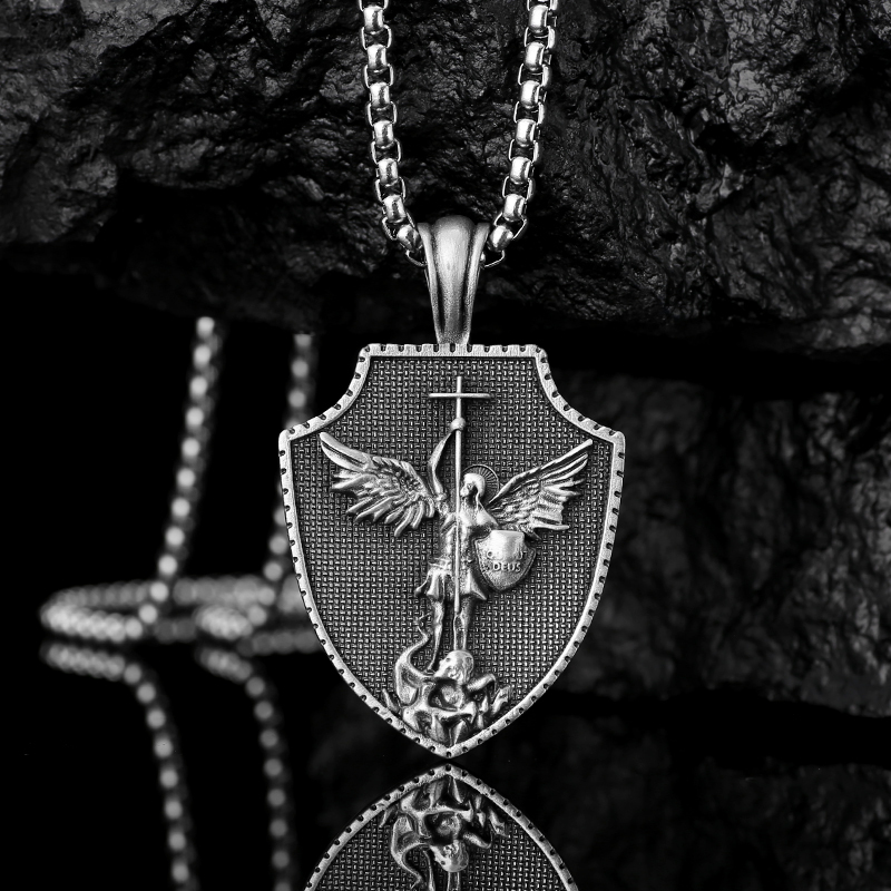 Solid lead-free pewter shield pendant featuring a 3D relief of St. Michael the Archangel defeating a dragon with a cross spear