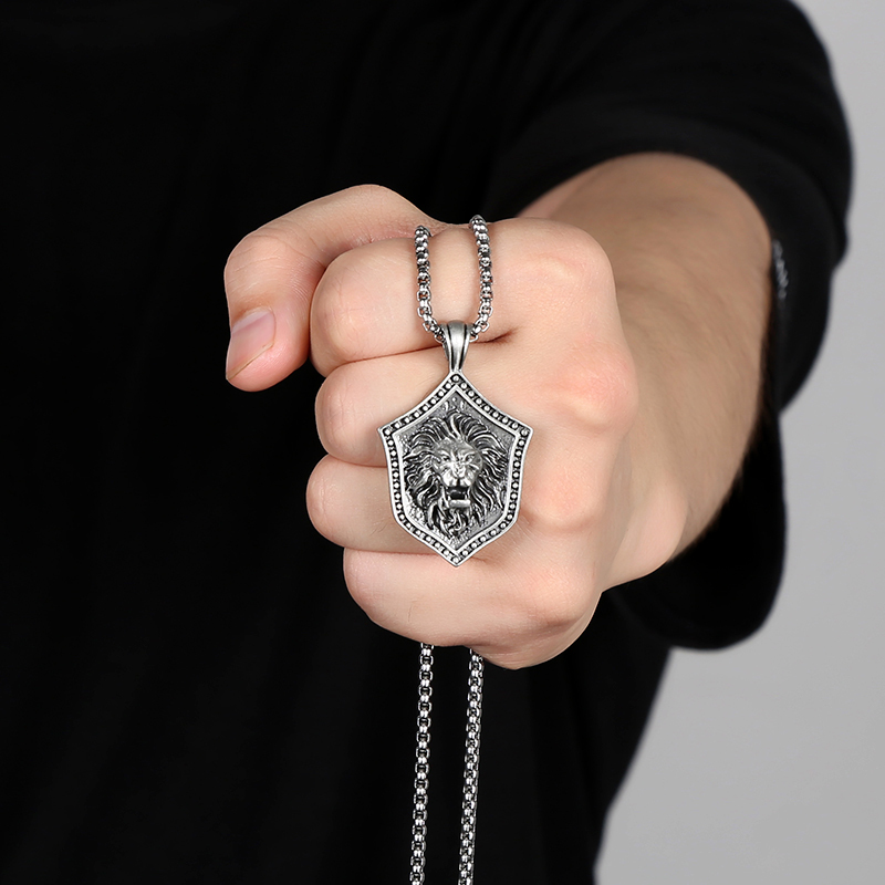 Solid lead-free pewter pendant featuring a 3D relief of a roaring lion head mounted on a medieval studded shield
