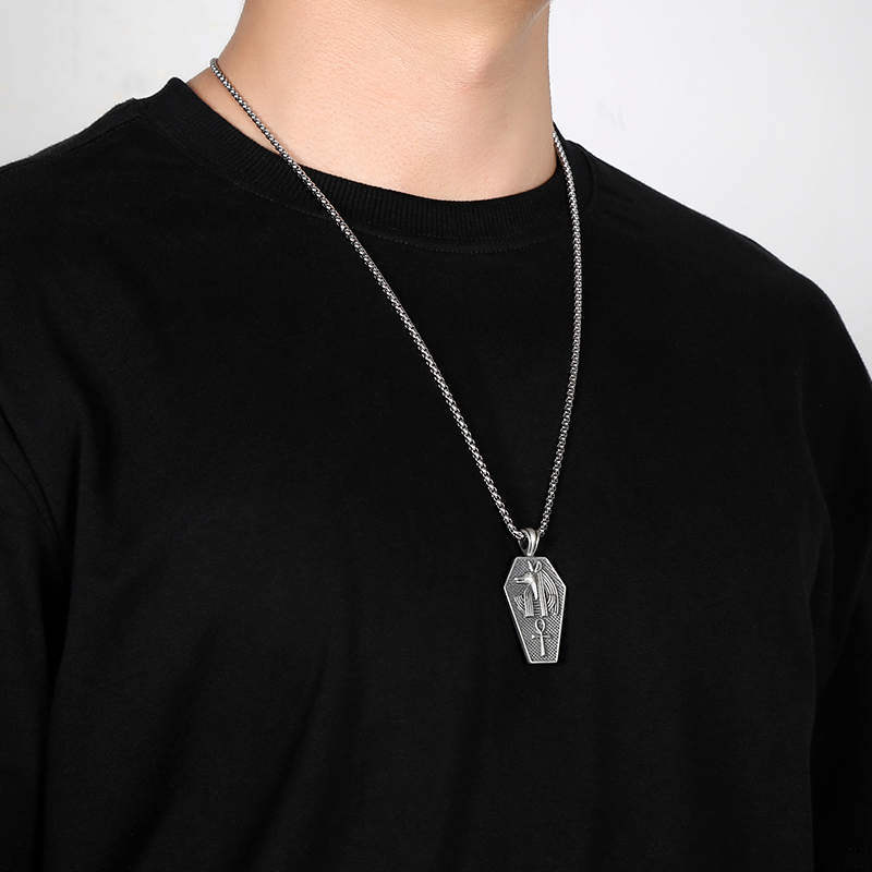 Solid pewter pendant shaped like an ancient Egyptian sarcophagus featuring a 3D relief of the jackal god Anubis and an Ankh symbol