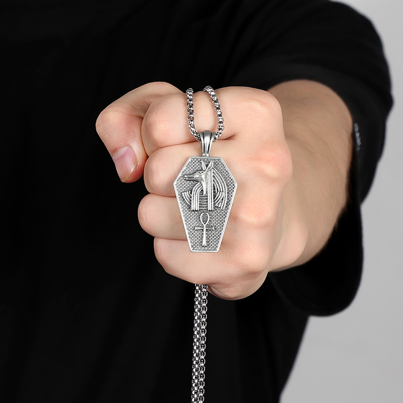 Solid pewter pendant shaped like an ancient Egyptian sarcophagus featuring a 3D relief of the jackal god Anubis and an Ankh symbol