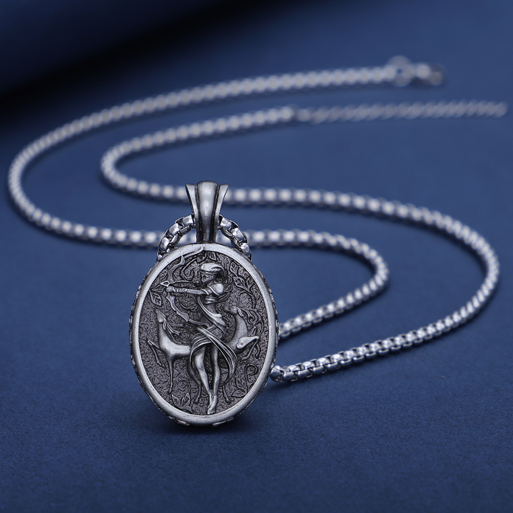 Solid lead-free pewter oval pendant featuring a detailed 3D relief of the Greek Goddess Artemis drawing a bow, accompanied by a sacred stag in a wild forest setting