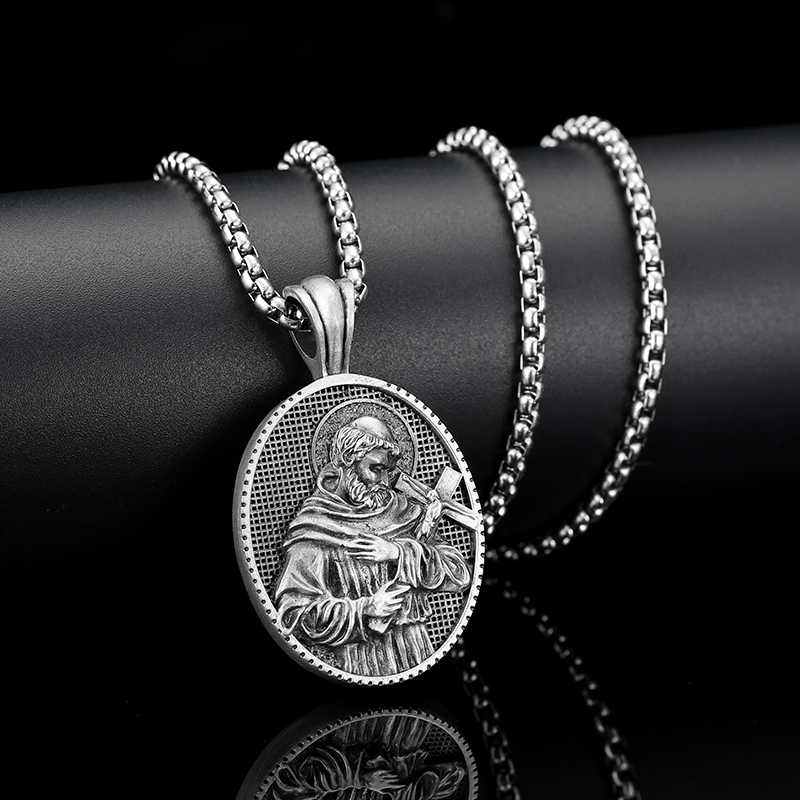 Solid lead-free pewter oval Catholic pendant featuring a 3D relief of Saint Francis of Assisi in a monk's habit holding a crucifix against a textured background