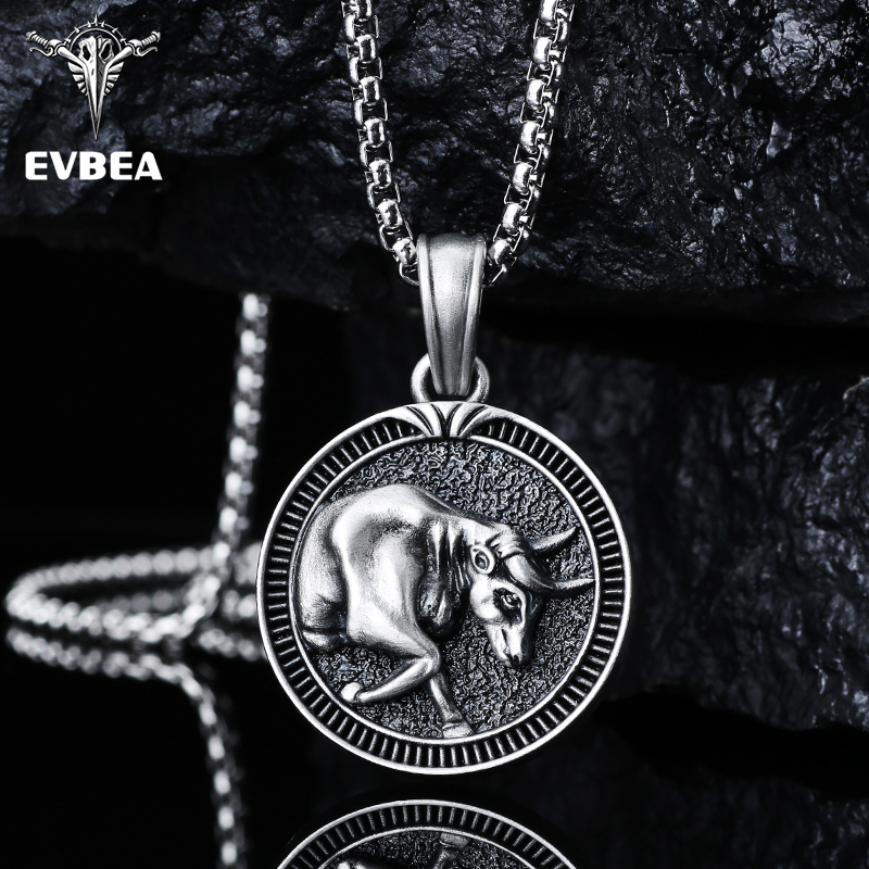 Solid lead-free pewter round medallion pendant featuring a 3D relief of a charging bull with a textured background and a grooved coin-like border