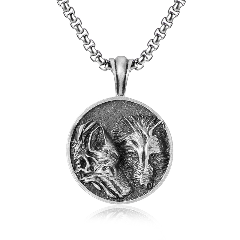 Solid lead-free pewter round medallion pendant featuring a highly detailed 3D relief of two wolves side-by-side against a textured stippled background