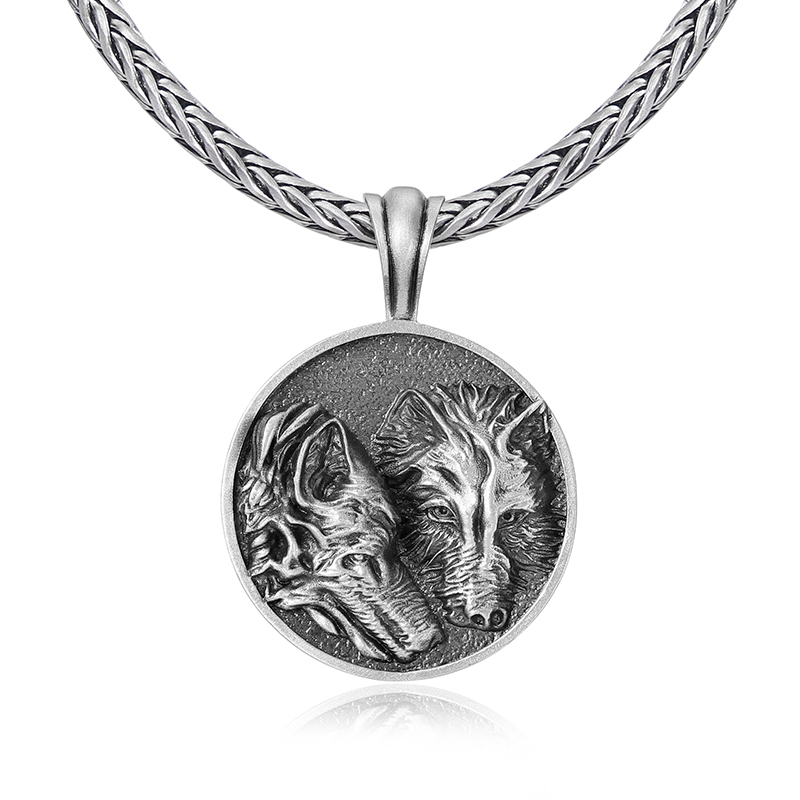 Solid lead-free pewter round medallion pendant featuring a highly detailed 3D relief of two wolves side-by-side against a textured stippled background