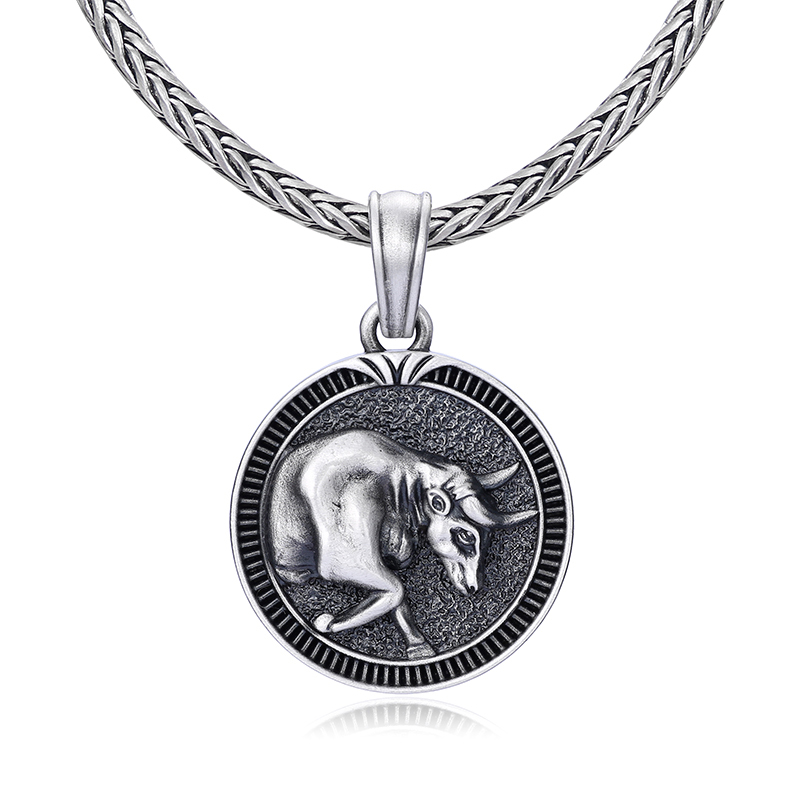 Solid lead-free pewter round medallion pendant featuring a 3D relief of a charging bull with a textured background and a grooved coin-like border