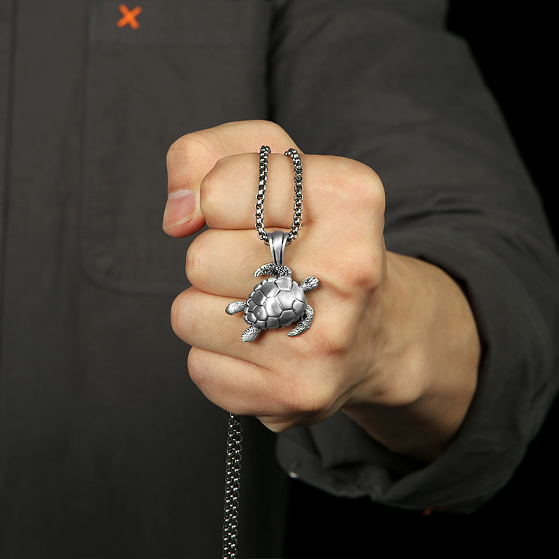 Close-up of hand-brushed solid pewter sea turtle shell and flipper textures with EVBEA stamp