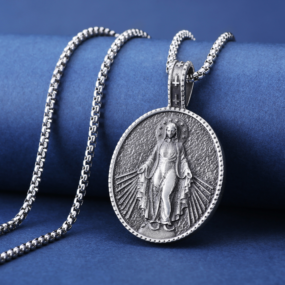 Close-up of hand-brushed solid pewter Virgin Mary rays of light and cross bail with EVBEA stamp