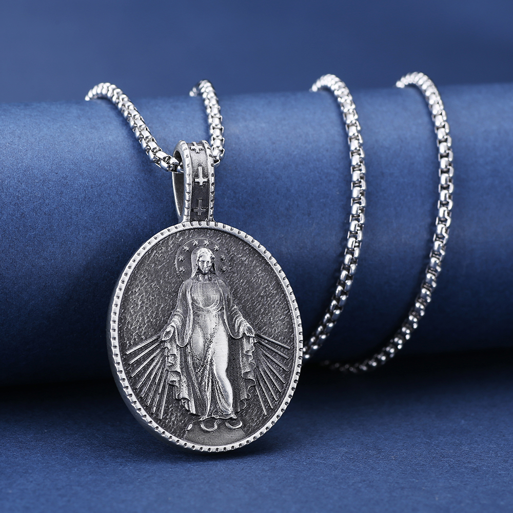 Close-up of hand-brushed solid pewter Virgin Mary rays of light and cross bail with EVBEA stamp