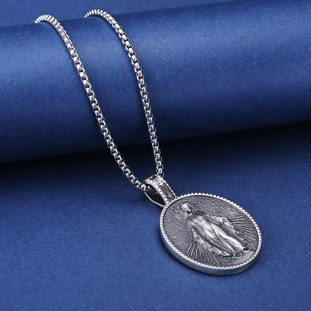 Close-up of hand-brushed solid pewter Virgin Mary rays of light and cross bail with EVBEA stamp