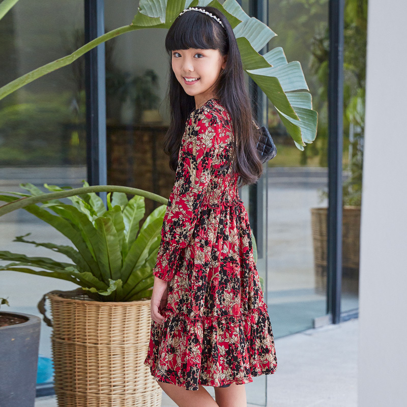 New children's dress with a red base and floral patterns, featuring a waist - cinching design and long sleeves, and retro prints.