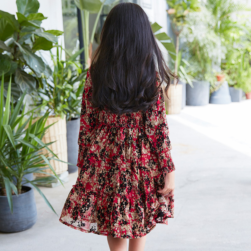 New children's dress with a red base and floral patterns, featuring a waist - cinching design and long sleeves, and retro prints.