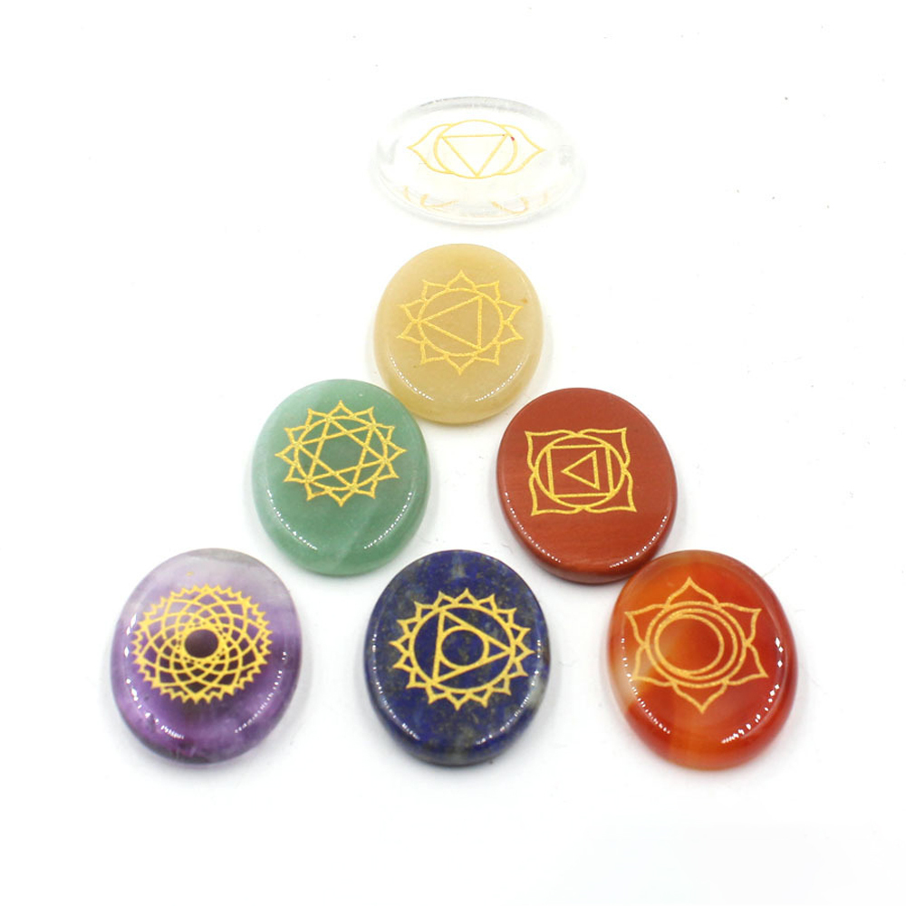 Chakra stone set - healing crystal with carved chakra symbols of oval stone chakra stone artifacts