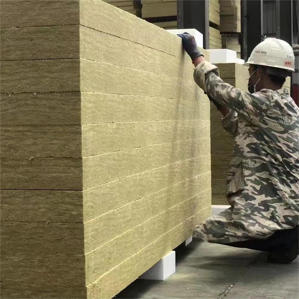 Professional worker checking the thickness and quality of high-density rock wool board stacks.---LiLuan Technology