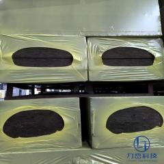 Black fireproof rock wool board stacked in warehouse with protective wrapping - high-density acoustic and fire insulation by Liluan Technology