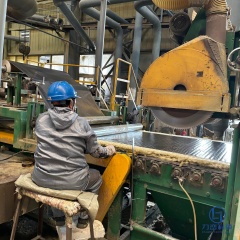 Factory worker operating automated production line for foil faced rock wool board insulation used in HVAC ducts - Liluan Technology