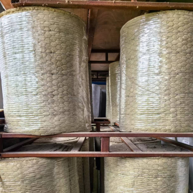 Large rolls of heat resistant rock wool blanket neatly stacked in warehouse ready for industrial insulation projects - Liluan Technology