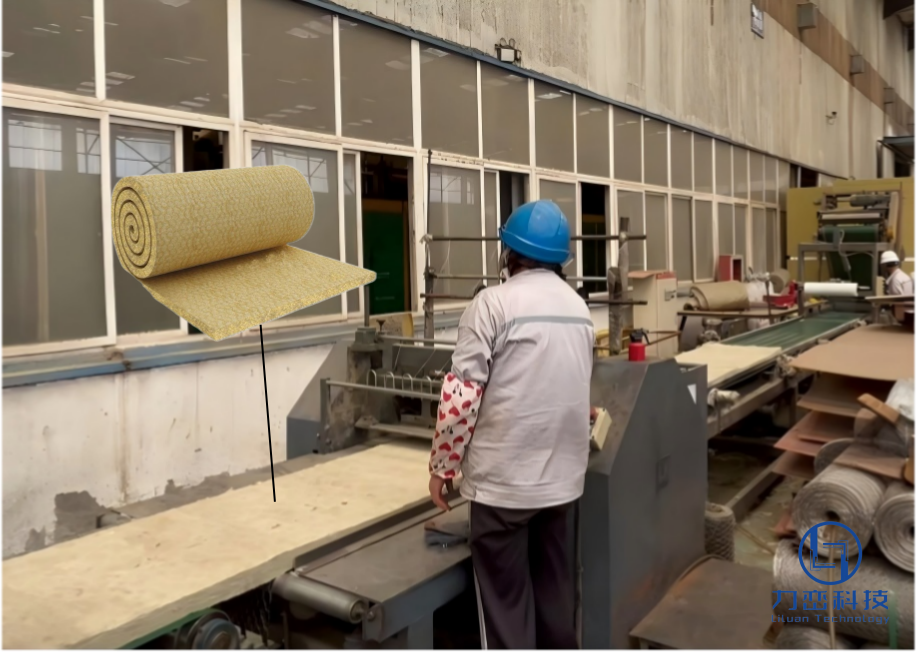 Factory worker handling bare rock wool blanket roll on production line - real manufacturing process for industrial insulation at Liluan Technology